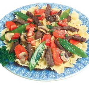 Beef Stir Fry over Pasta on Blue and White Plate Food Picture