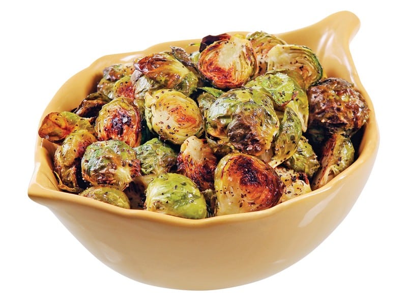 Cooked brussel sprouts in a tan bowl on a white background Food Picture