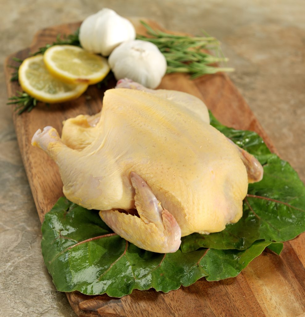 Whole Raw Cornish Hen on Cutting Board Food Picture