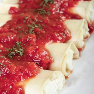 Manicotti with Garnish on Green Plate Food Picture