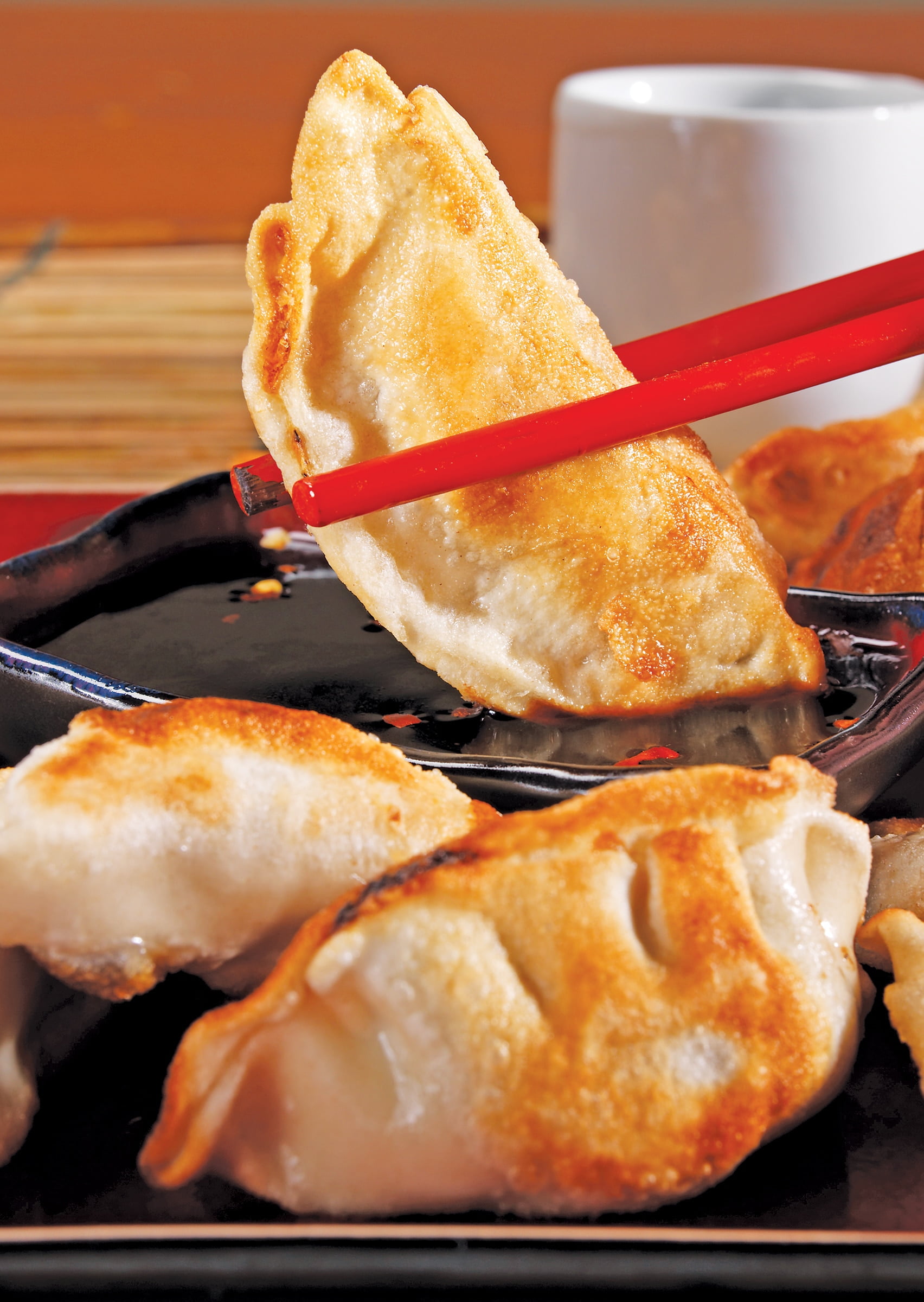 Pan Fried Potsticker's with Red Chopsticks Food Picture