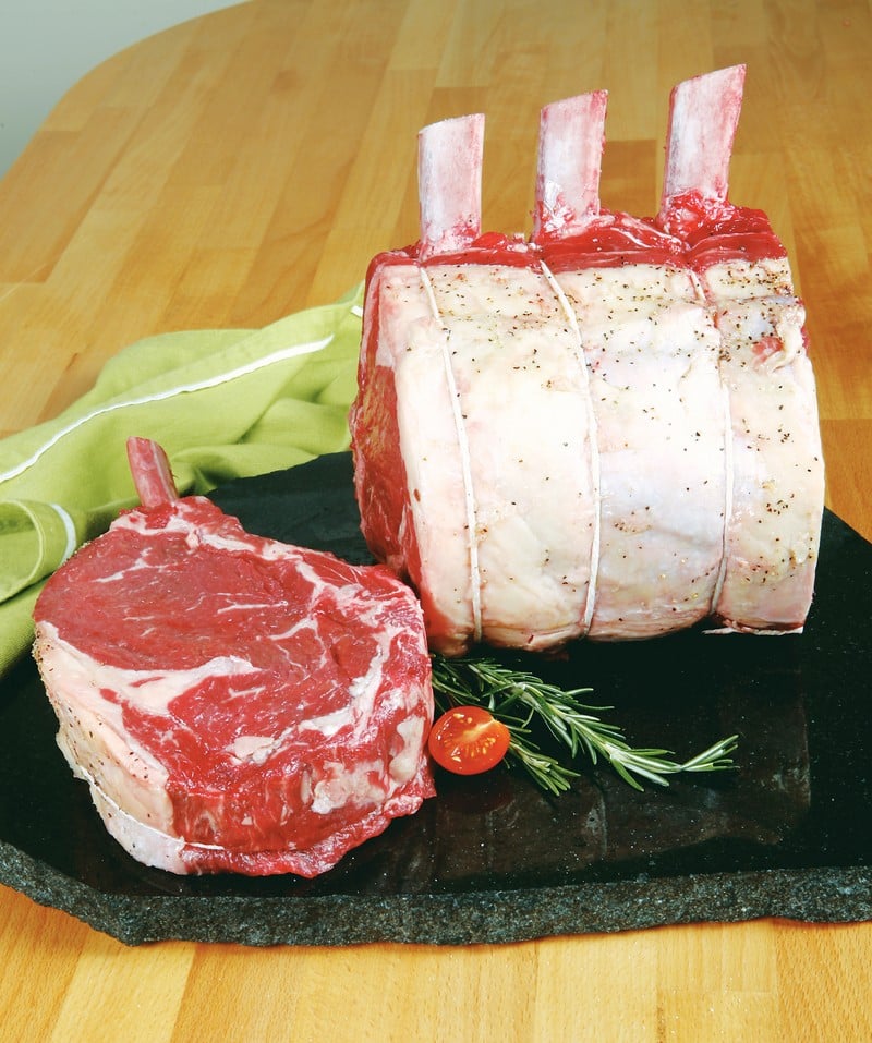 Raw Beef Rib Roast Standing on a Black Stone Food Picture